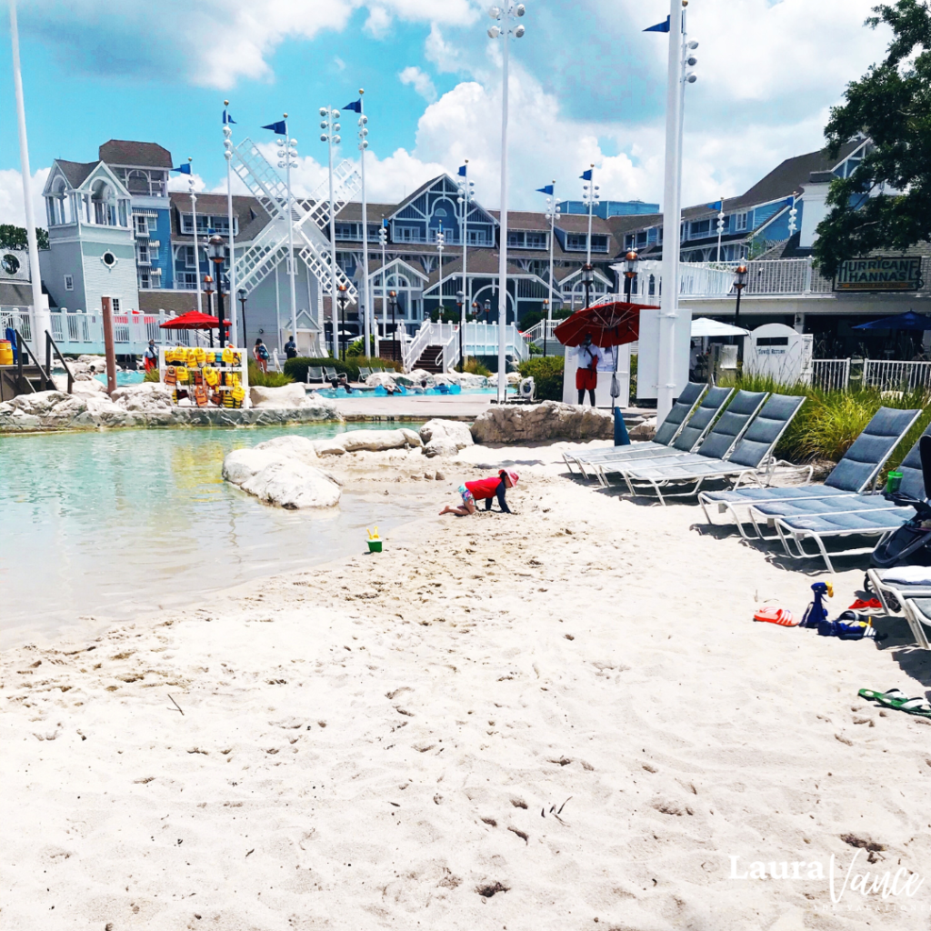 A young girl swims at Stormalong Bay, the beach-themed pool at Disney’s Yacht and Beach Club Resort—one of the best ways to stay cool at Disney World.